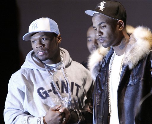 Rap artists 50 Cent, left, and The Game, shake hands during a news conference at the Schomburg Center for Research in Black Culture in the Harlem section of  New York, Wednesday, March 9, 2005. The two rappers, who have been feuding  for weeks announced an end to the disagreement and joint donations to the Boys Choir of Harlem. (AP Photo/Gregory Bull)