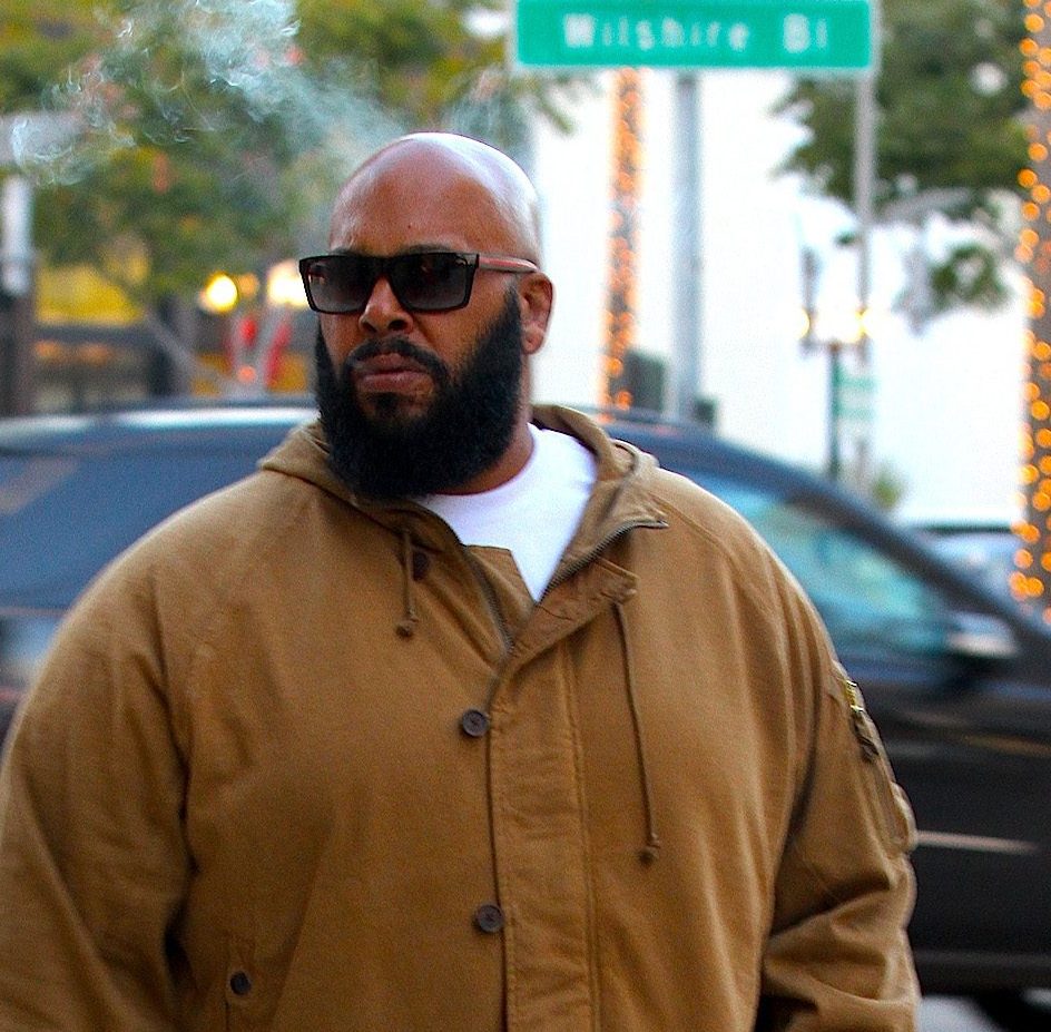 Hip-Hop Producer Suge Knight sighted smoking a cigar walking on Wilshire Boulevard