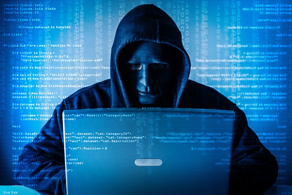 The abstract image of the hacker wear a mask using a laptop in the empty white room overlay with source code hologram. the concept of cyber attack, virus, malware, illegally and cyber security.