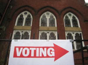 A sign pointing to a polling station is