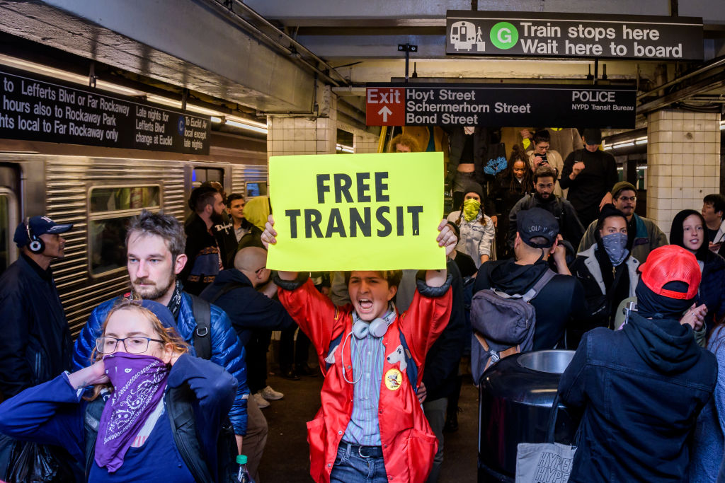 Hundreds of protesters took over a subway platform in...