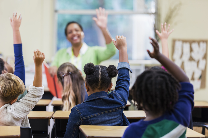 Teacher and students in elementary school classroom