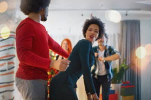 Young couple dancing at party.