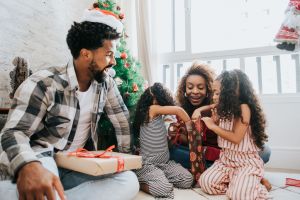 Family celebrating Christmas at home with gifts