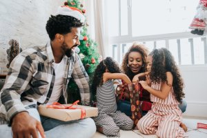Family celebrating Christmas at home with gifts