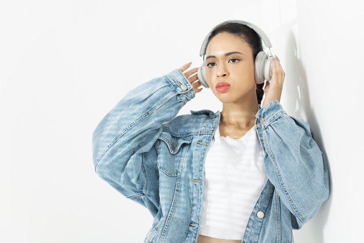 A woman listening to music with headphones.