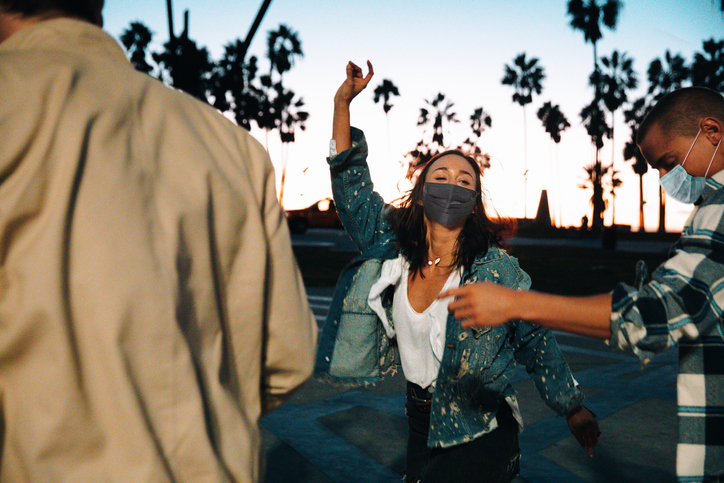 Happy friends celebrating and dancing together