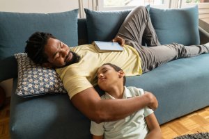 Father and son falling asleep together.