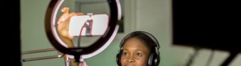 Young black woman recording a business podcast