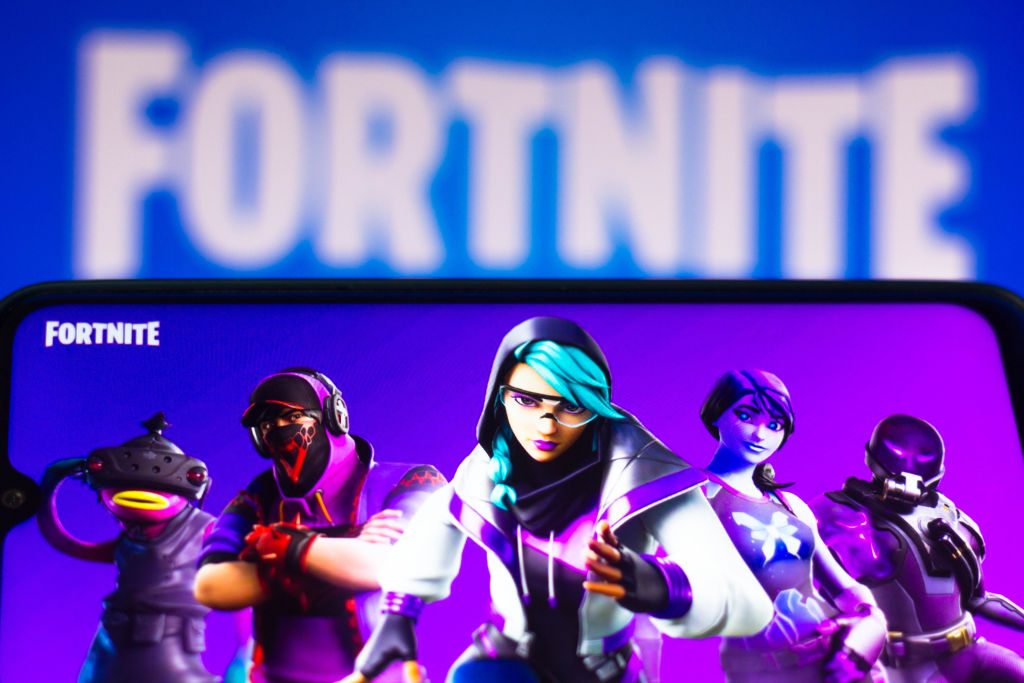 In this photo illustration the Fortnite logo is seen on a...