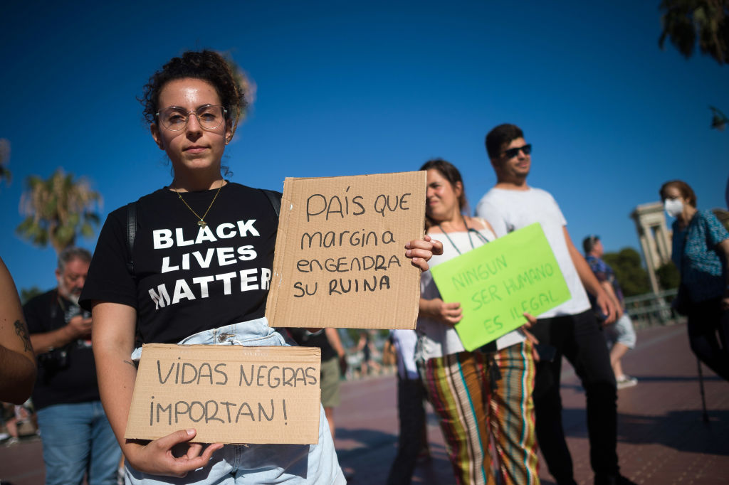 A protester wearing a T-shirt supporting the Black Lives...