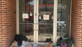 Homeless encampment in doorway of closed business, post pandemic city life, Queens, New York