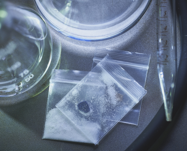 fentanyl opiate heroin methamphetamine in laboratory with beakers in bags with pill and powder