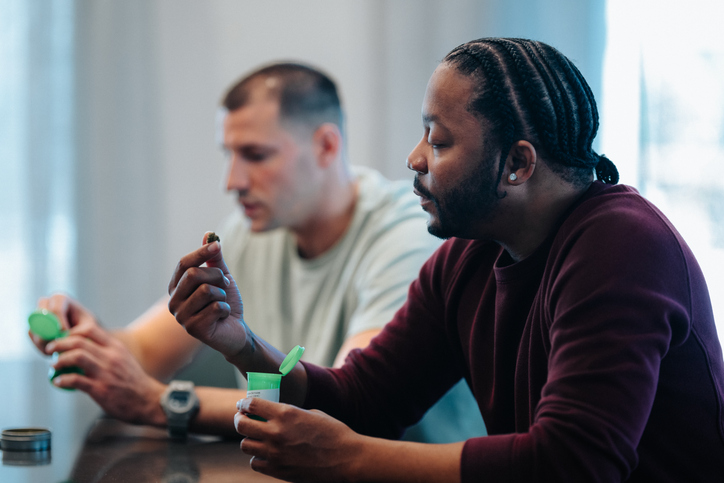 Male friends at home discussing medicinal marijuana