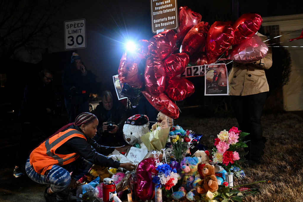 Sierra Rogers Makes Adjustments At A Makleshift Memorial For Tyre Nichols In Memphis, Tennessee