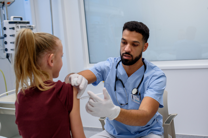 Doctor giving vaccine to kid during childhood immunization.