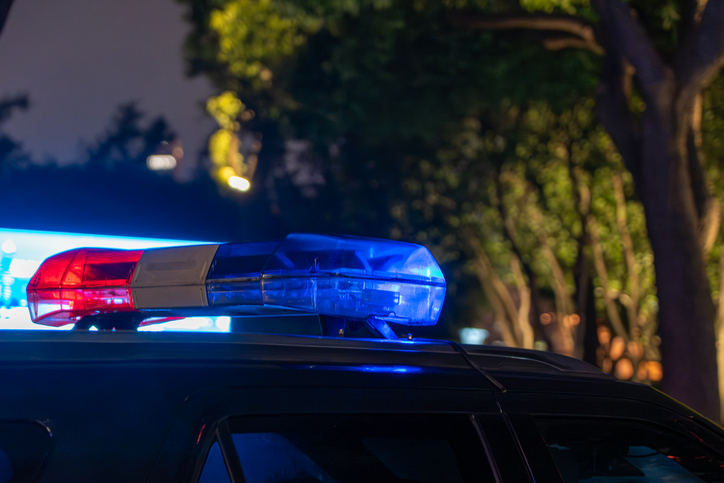 Close-up of Police Car Light Bar Flashing at Night